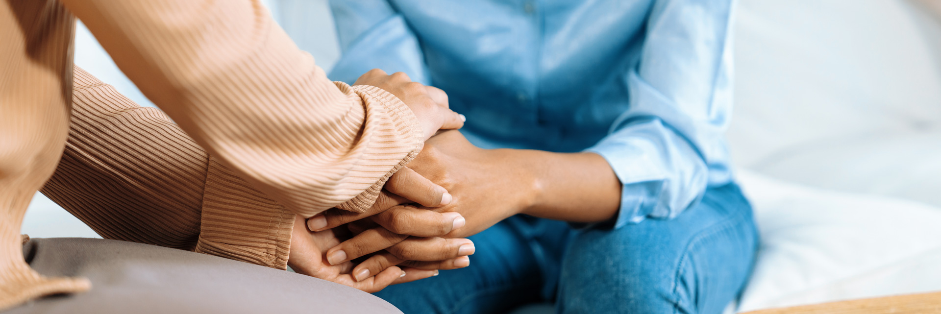 women's hands, supporting each other